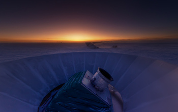 The sun sets behind BICEP2 and the South Pole Telescope.